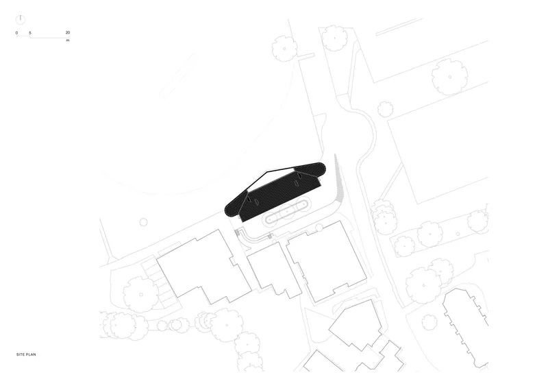Site plan drawing showing the curved building footprint among surrounding structures and landscape