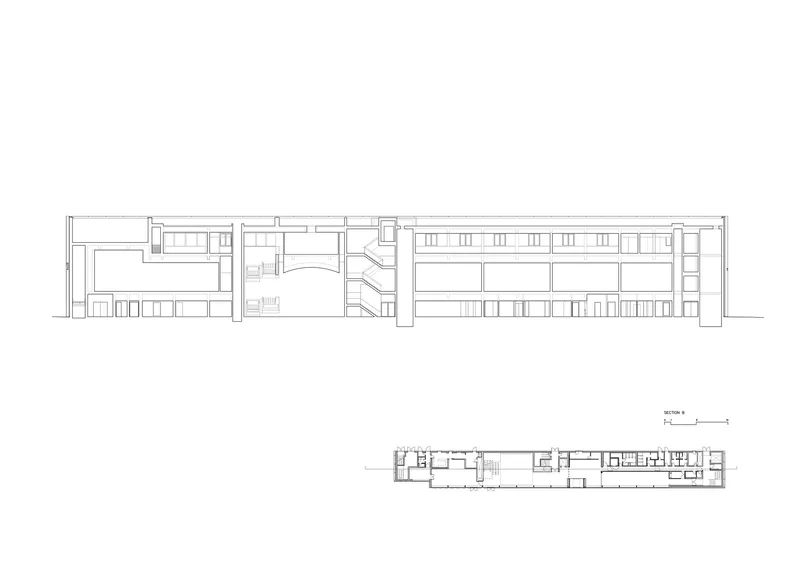 Section drawing revealing a central curved stair connecting split-level interior spaces with a small plan below