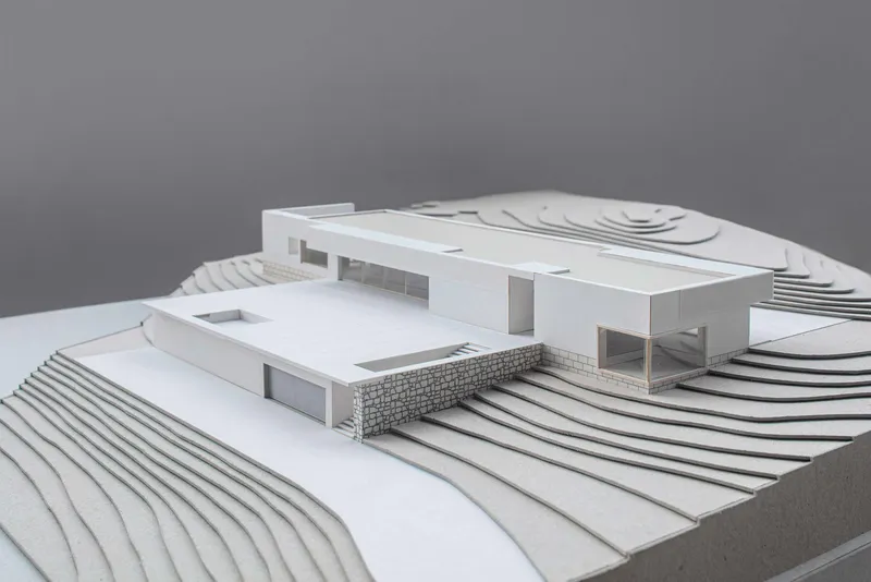 Physical model showing horizontal volumes on terraced topography with contour-like steps and platforms