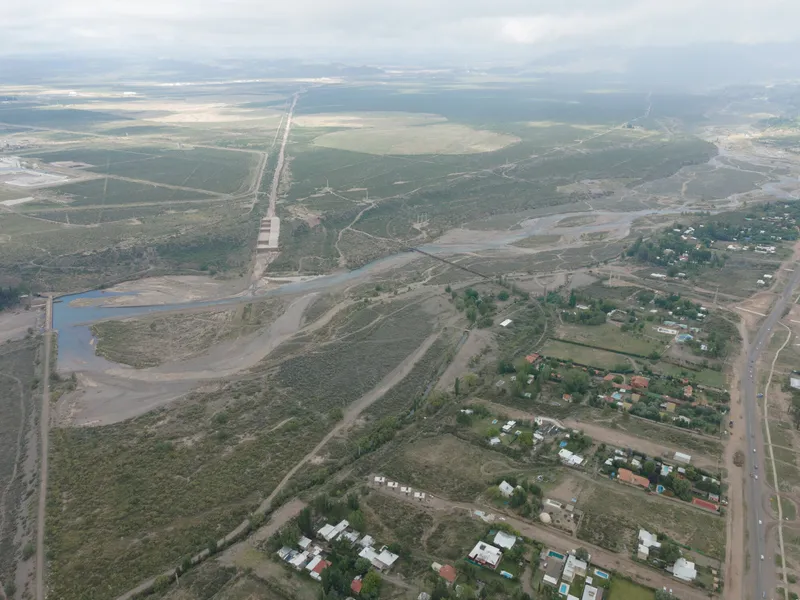 Wide aerial view showing the housing cluster within a patchwork landscape of roads and waterways