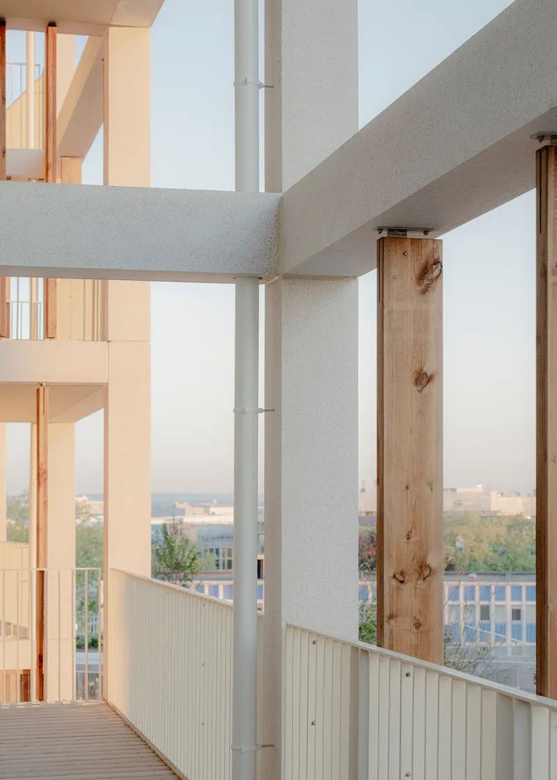 Close-up of the timber column connection to the precast concrete beam at an upper balcony