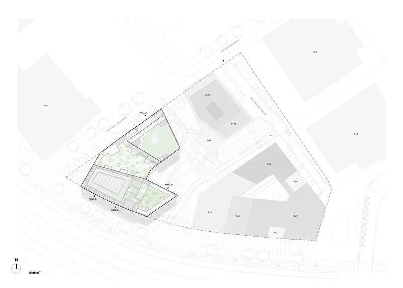 Site plan drawing showing angular building volumes with green courtyards among surrounding structures
