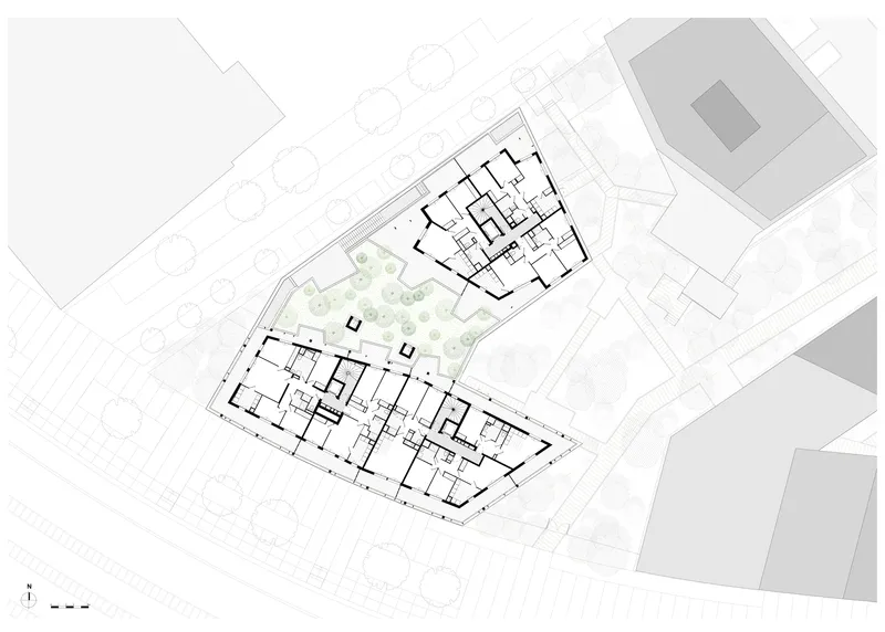 Upper floor plan drawing showing residential units flanking a central landscaped courtyard with trees
