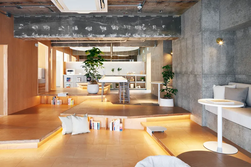 Sunken plywood lounge area with integrated book storage and pendant lighting overhead