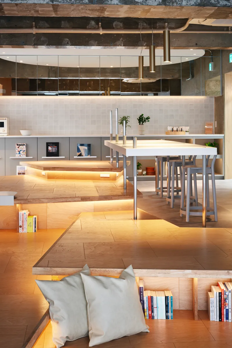View across sunken lounge area toward kitchen counter with integrated LED strip lighting