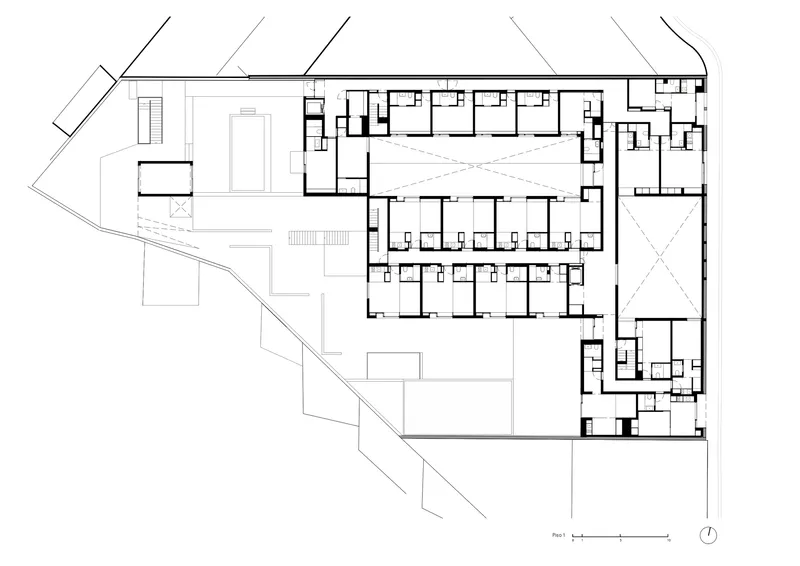 Floor plan drawing showing residential units arranged around a central courtyard with angular site boundaries