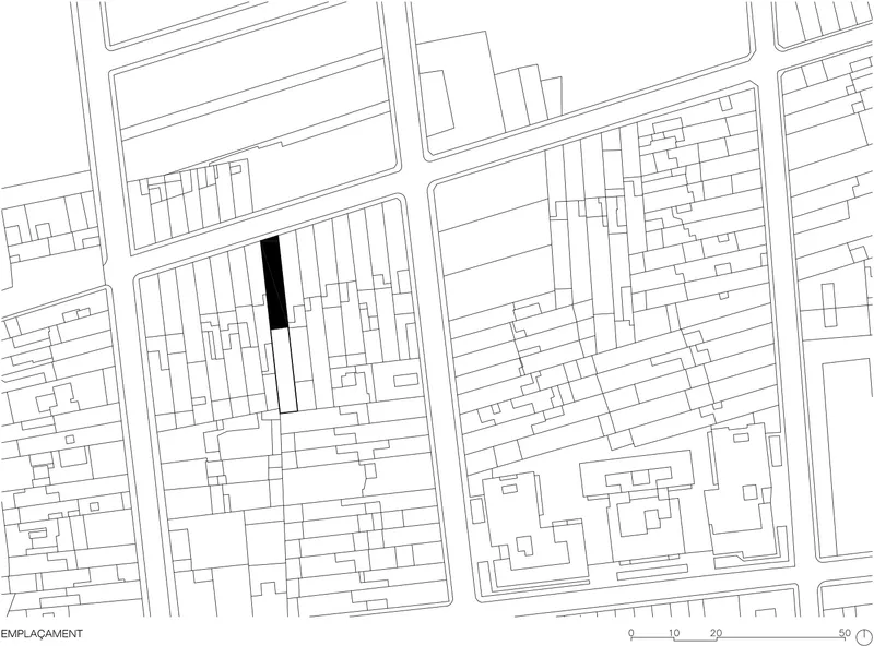 Site plan drawing showing a single filled footprint among surrounding urban blocks and street grid