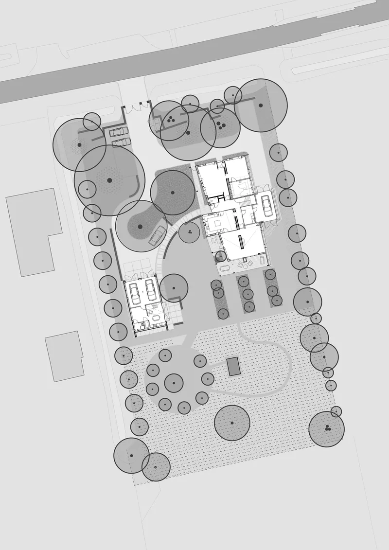 Site plan drawing showing three building volumes surrounded by tree canopies and landscaped areas