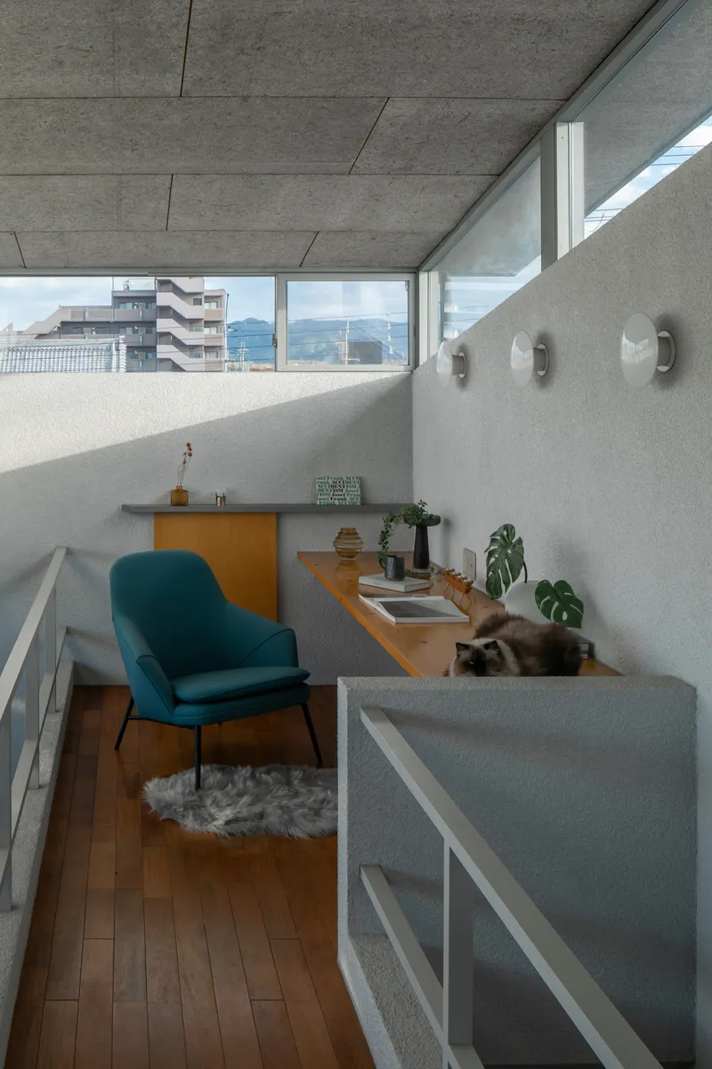 Mezzanine workspace with concrete countertop and clerestory windows overlooking distant mountains