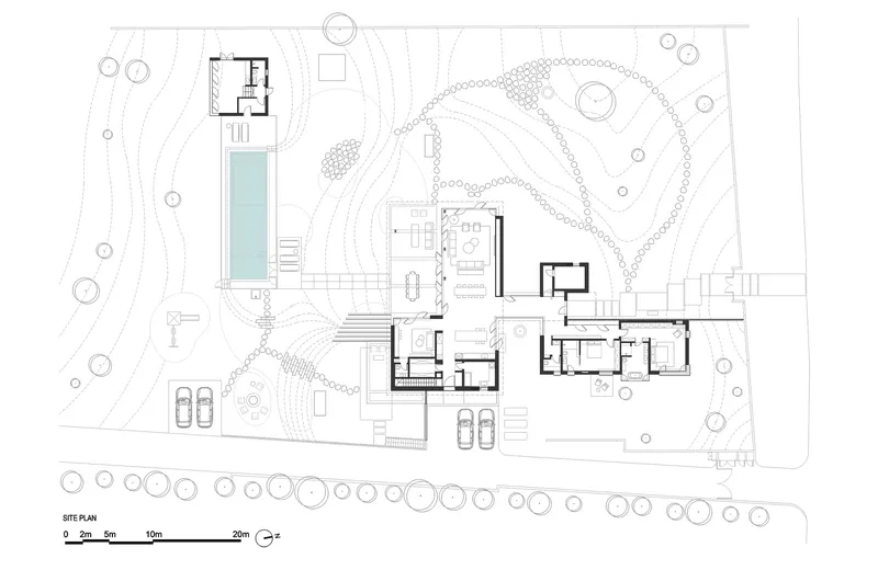 Site plan drawing showing dispersed building volumes around a pool and landscaped contours with trees