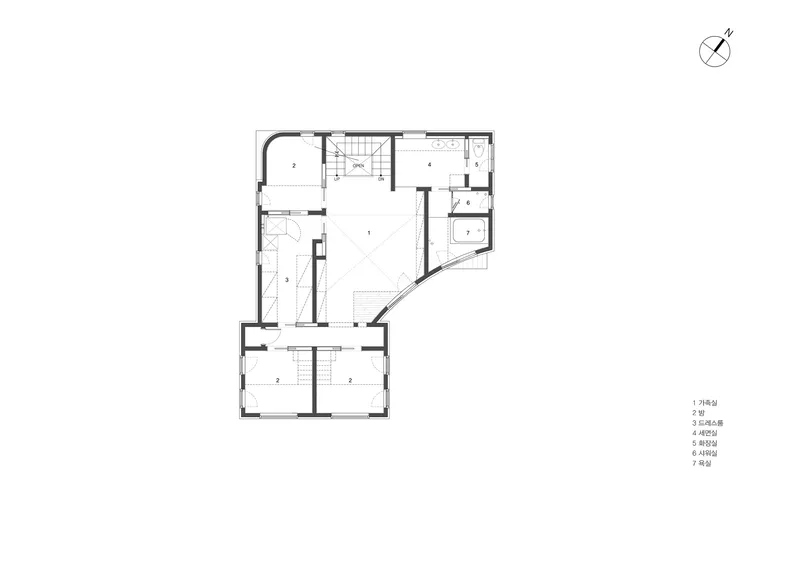 Upper floor plan drawing showing central stair with bedrooms and bathrooms arranged around an angled corner