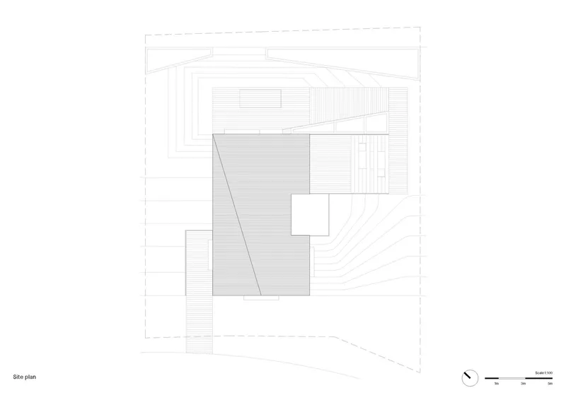 Site plan drawing showing building footprint on sloping terrain with contour lines