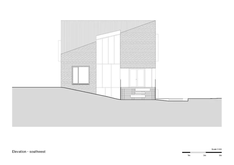 Southwest elevation drawing showing angled roof with tall vertical window and exterior stairs