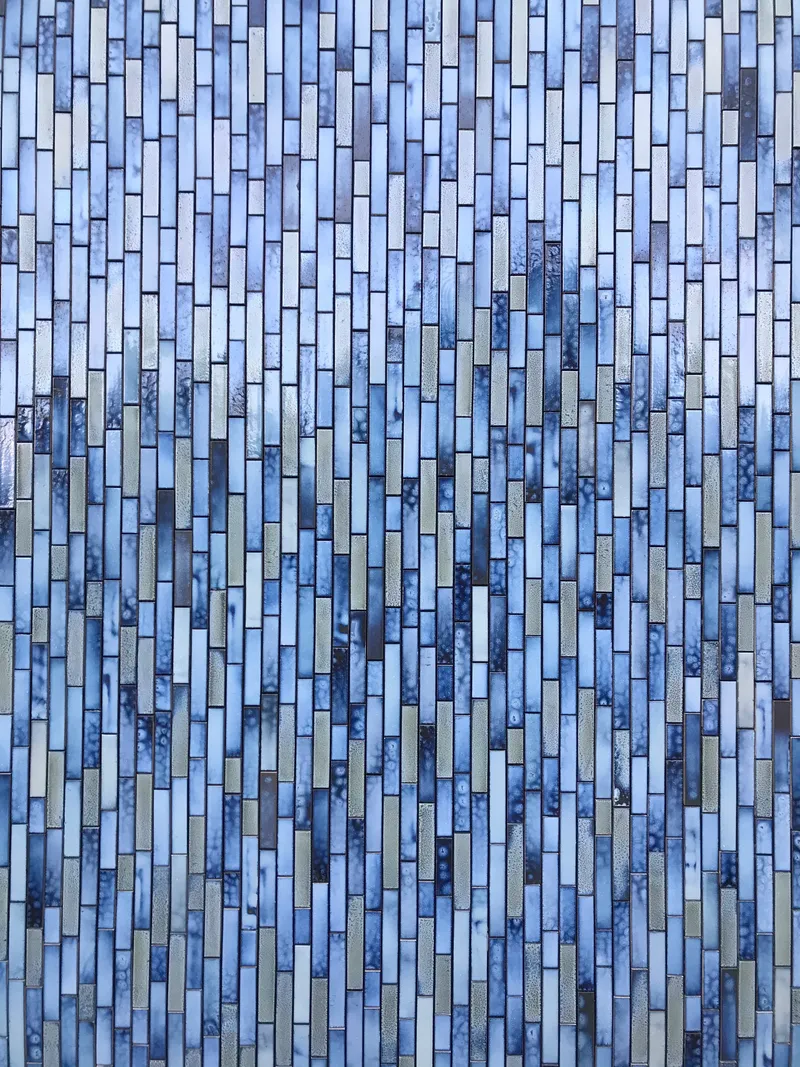 Close-up of the staggered blue and grey glazed tile pattern with varied tones and textures
