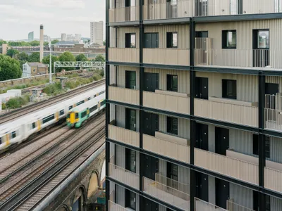 Studio Woodroffe Papa Wraps 111 Apartments Around a Courtyard with Saw-Tooth Balconies in Bermondsey