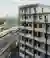 Studio Woodroffe Papa Wraps 111 Apartments Around a Courtyard with Saw-Tooth Balconies in Bermondsey