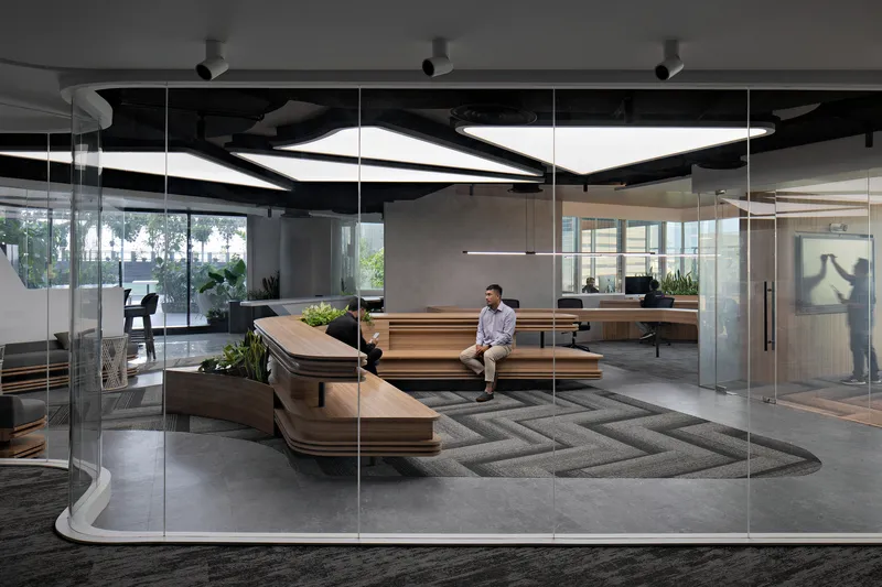 Reception lounge with tiered timber benches viewed through floor-to-ceiling glass wall