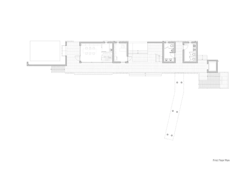 First floor plan drawing showing a linear layout with an angled wing extending from the main volume