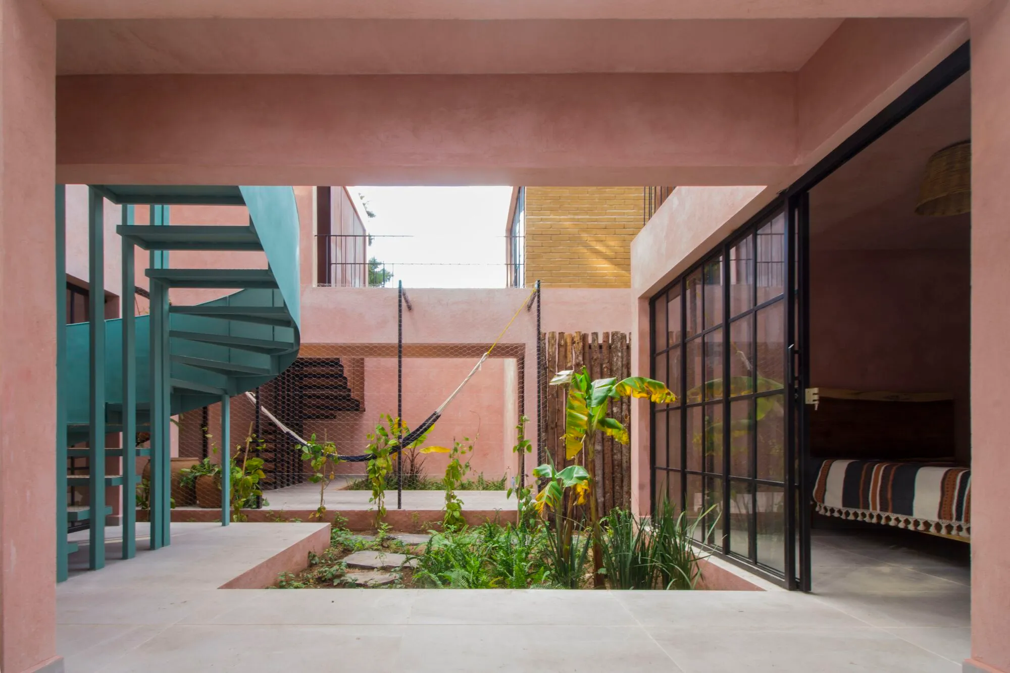 Apaloosa Builds a Forest-Edge Retreat from Compacted Earth and Pink Stucco in Chiapas