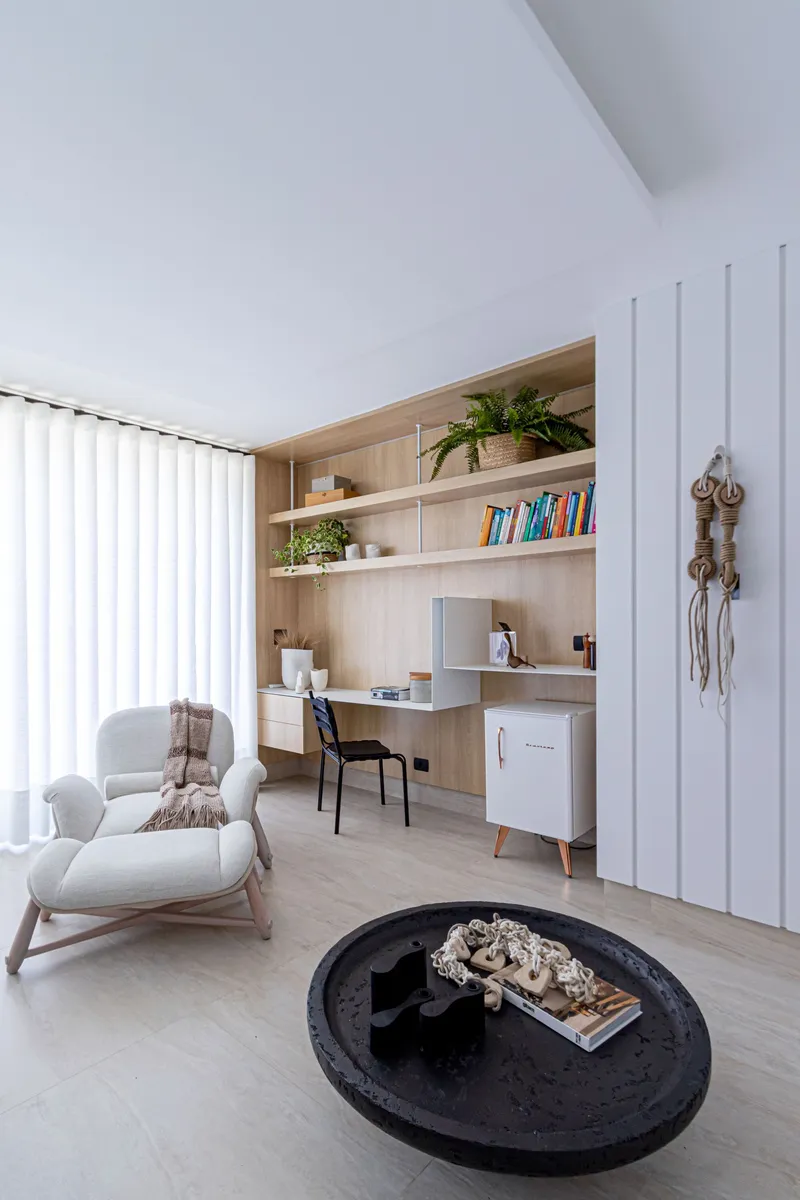 Home office nook with built-in timber shelving and vertical white panel wall