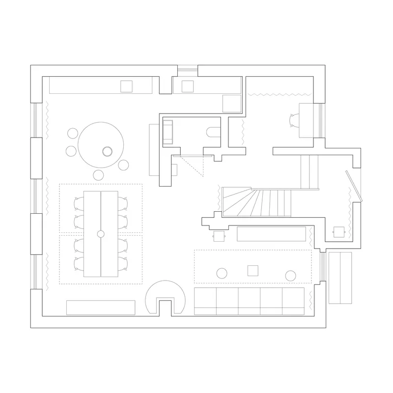 Floor plan drawing showing open living and dining areas with central stair and bathroom core