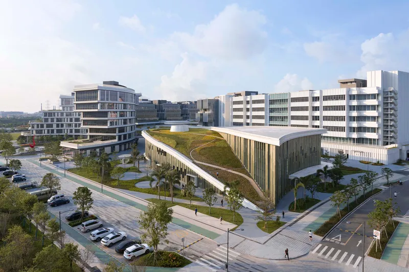 Street corner view of a green roof pavilion with vertical louvers and parked cars