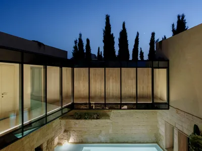 Valentino Architects Thread a Glazed Walkway Through Three 16th-Century Stone Houses in Malta
