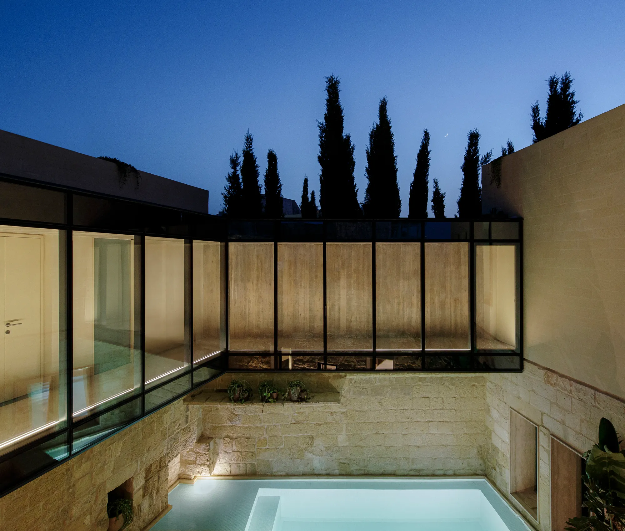 Valentino Architects Thread a Glazed Walkway Through Three 16th-Century Stone Houses in Malta