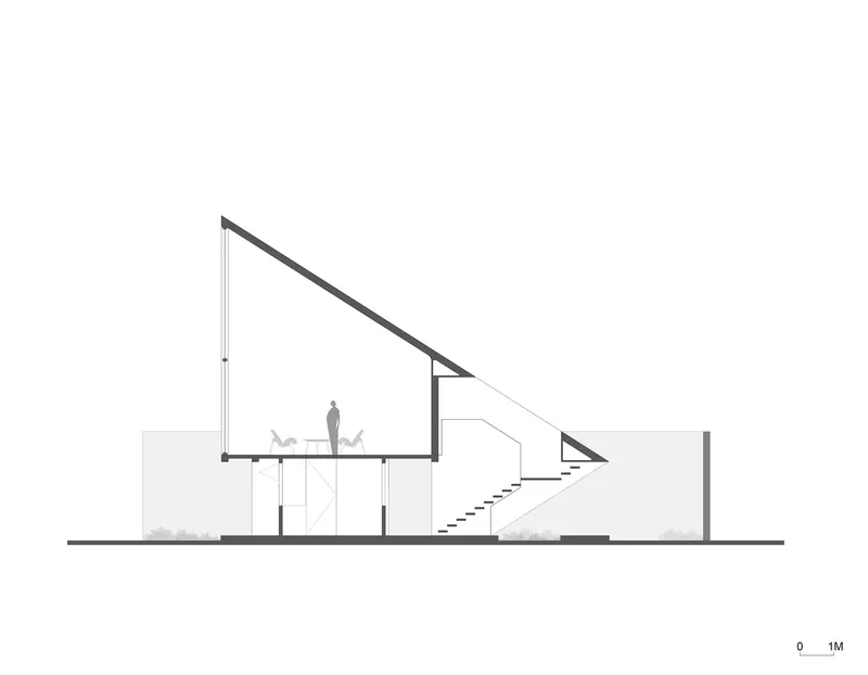 Section drawing showing the sloped roof profile over double-height spaces with a central staircase and figure