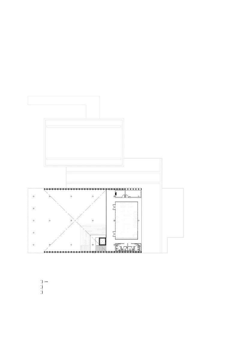 Floor plan drawing showing a main wing with diagonal circulation paths and a smaller rectangular annex