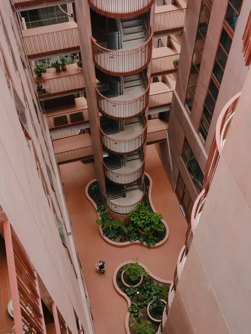 Looking down into the internal courtyard with curved planting beds and cylindrical balcony tower