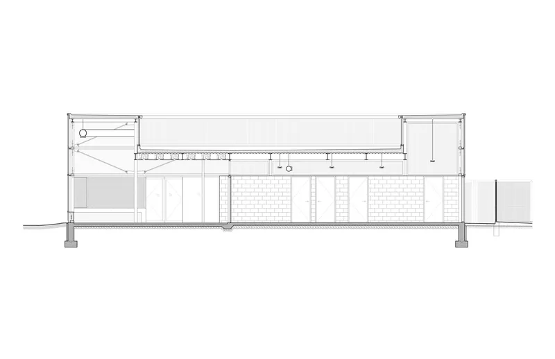 Building section drawing showing the single-story structure with exposed roof trusses and clerestory glazing