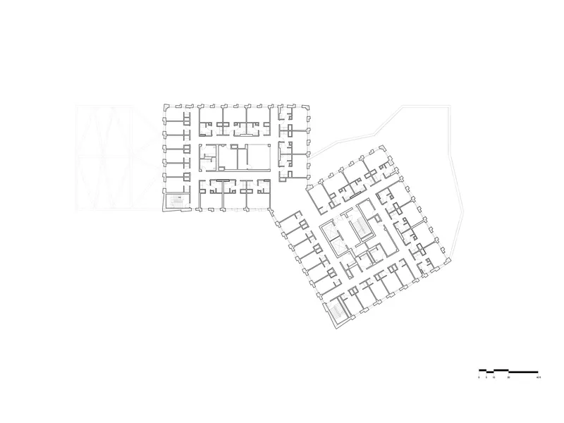 Floor plan drawing showing two rectangular volumes linked by a connecting element with central courtyard spaces
