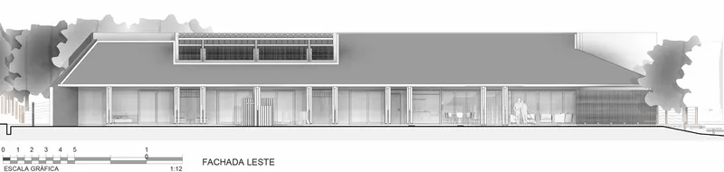 East elevation drawing showing long horizontal facade with clerestory band and overhanging roof