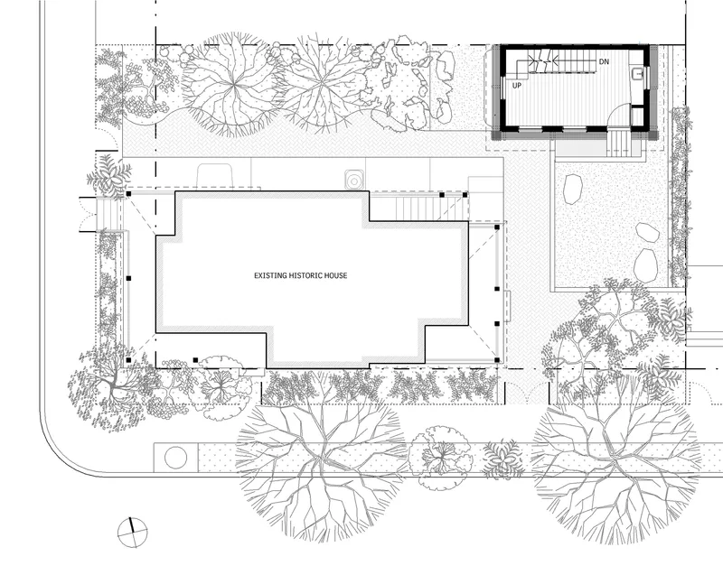 Site plan drawing showing an existing house surrounded by landscaping and a new addition with stair