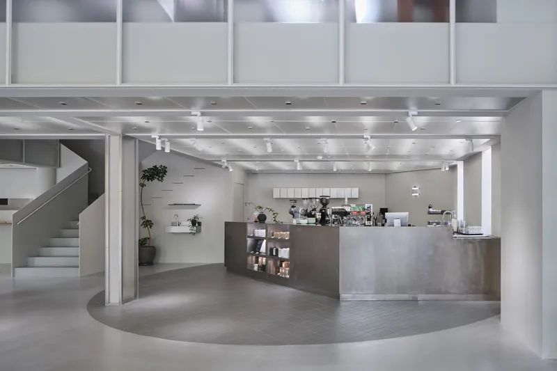 View of the cafe counter with exposed metal ductwork and track lighting overhead