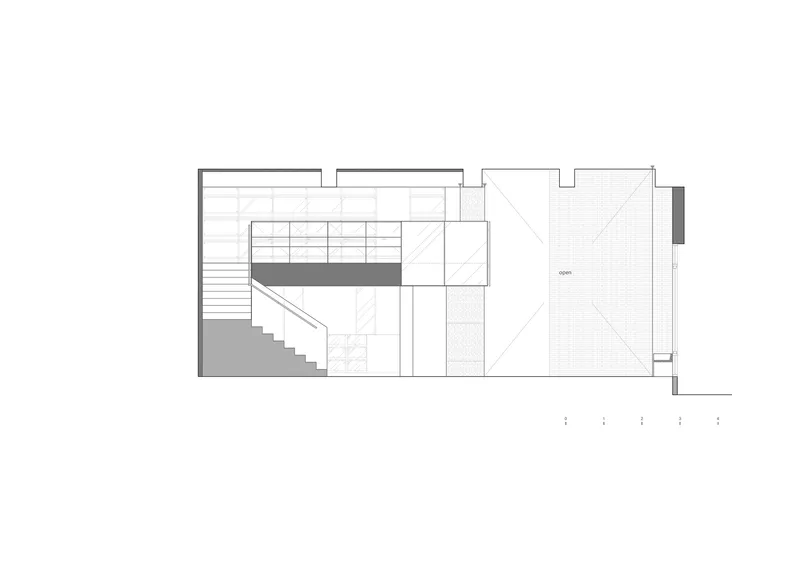 Section drawing showing a staircase ascending along an interior wall with adjacent open courtyard