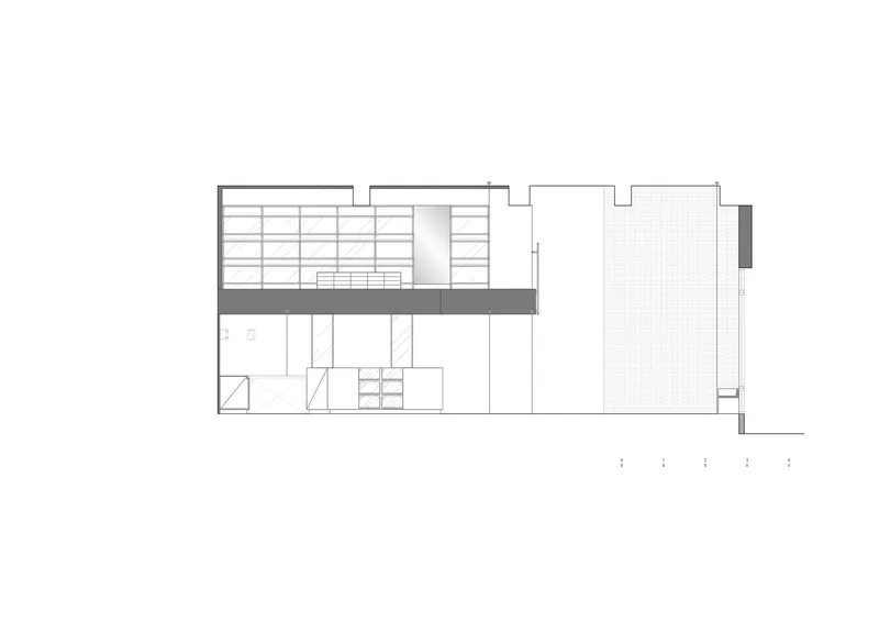 Section drawing depicting a mezzanine level with bookshelves and an open courtyard to the right