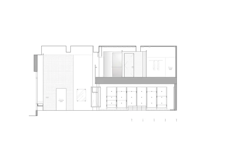 Section drawing showing a narrow vertical circulation core separating spaces with a courtyard on the left