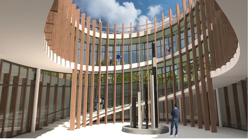 A dramatic central atrium connects multiple levels through natural light, vertical circulation, and visual transparency.