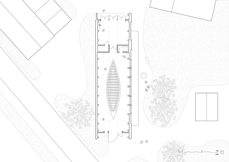 Floor plan drawing showing elongated building with boat-shaped element and adjacent structures with trees