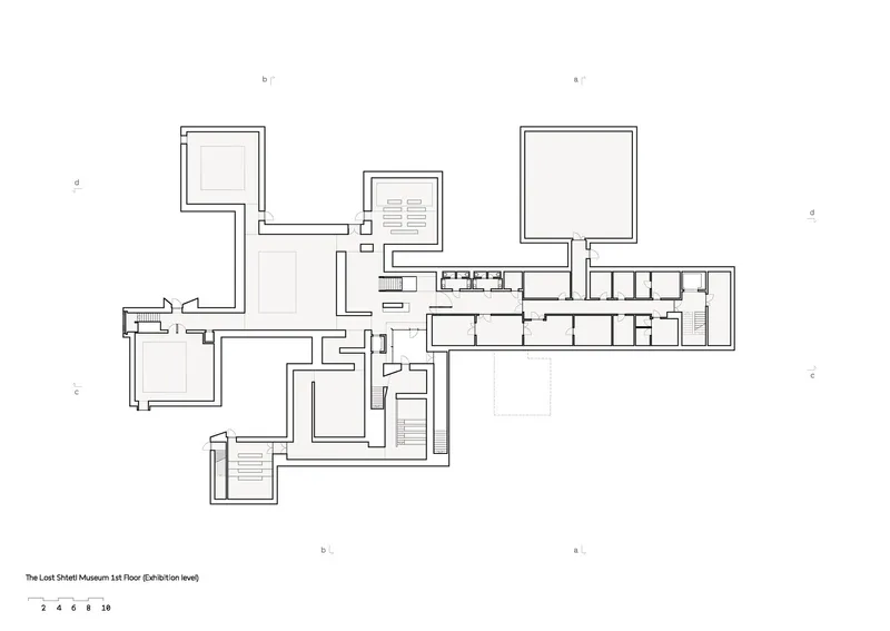 Floor plan drawing showing interconnected cubic volumes and a linear gallery wing