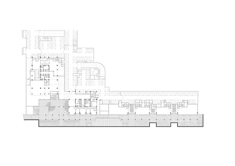 Floor plan drawing showing an irregular L-shaped layout with columnar grid and extended wing