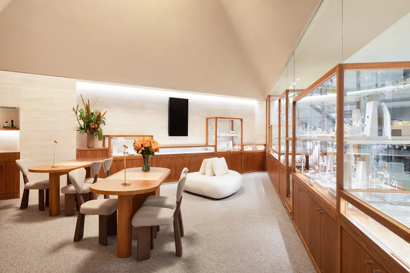 View toward timber-framed glass display cases along the wall opposite a clerestory window