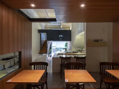 Atelier Waterside Threads a Timber Box Through a 1930s Guangzhou Tenement for Qualia Café