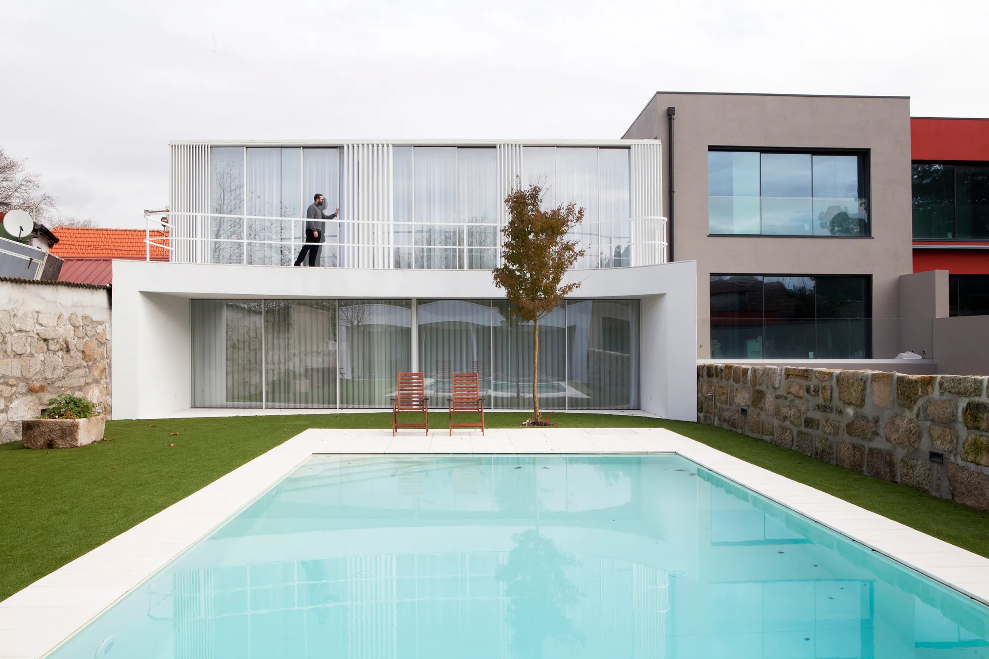 A2OFFICE Curves a Porto House Around a Preserved Tree and an Open Patio