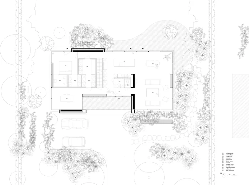 Ground floor plan drawing revealing open living spaces and service rooms within landscaped site