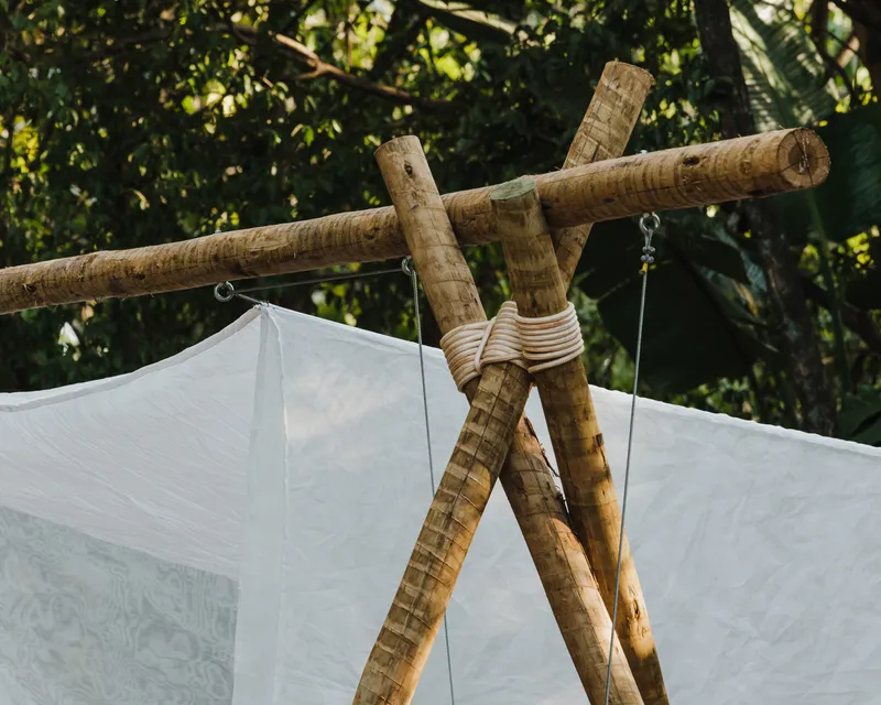 Detail of lashed bamboo poles joined with rope at the apex of the timber frame