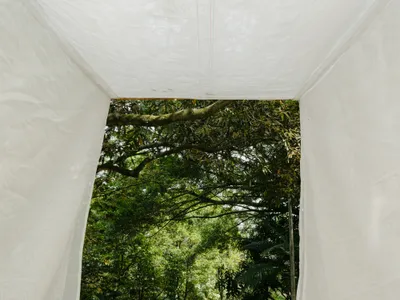 Gustavo Utrabo Suspends a Fabric Threshold Between the Trees of a São Paulo Park