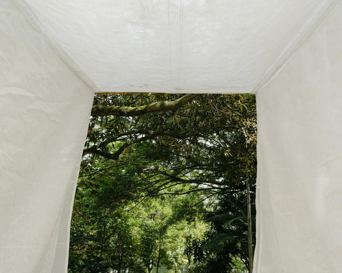 Gustavo Utrabo Suspends a Fabric Threshold Between the Trees of a São Paulo Park